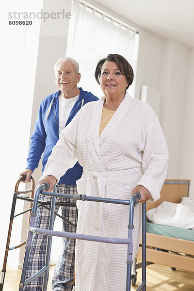 Senior man and woman with walking frame