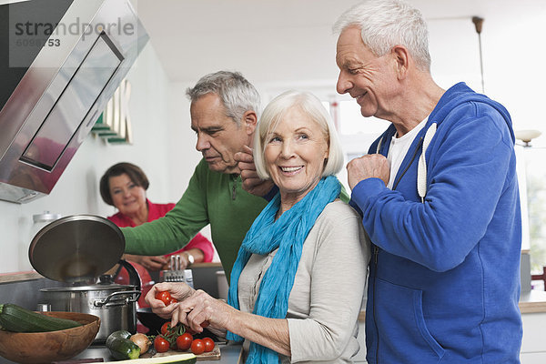 Senior men and women cooking food