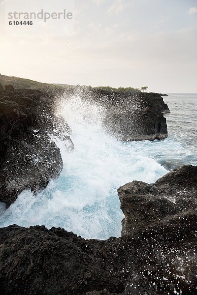 Felsbrocken über Steilküste Lava Wellen brechen