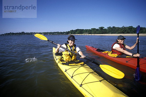 Two women sea kayaking  Chesapeake Bay  Maryland