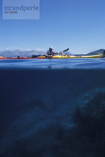 Sea kayaker paddles  Croatia's coast.