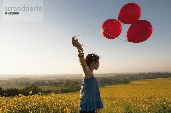 Mädchen mit Ballons im Feld