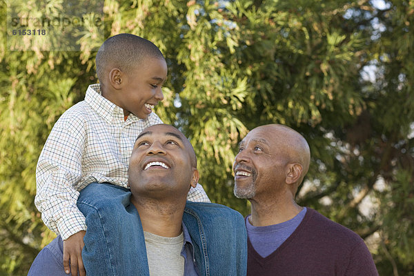 African grandfather  father and son in park