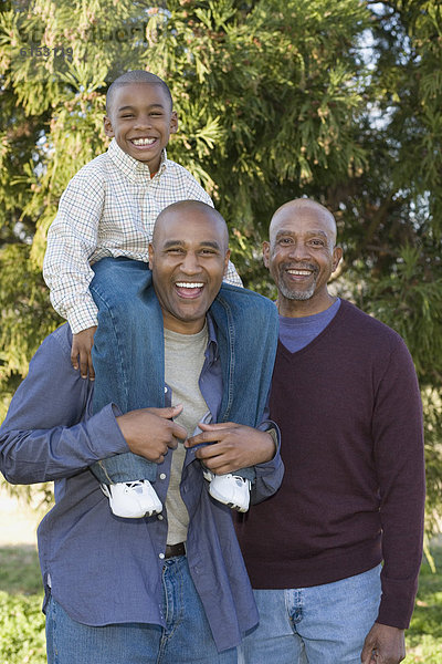 African grandfather  father and son in park