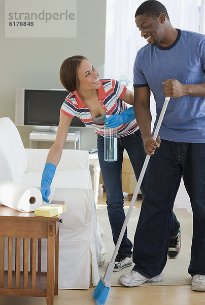 African couple cleaning house