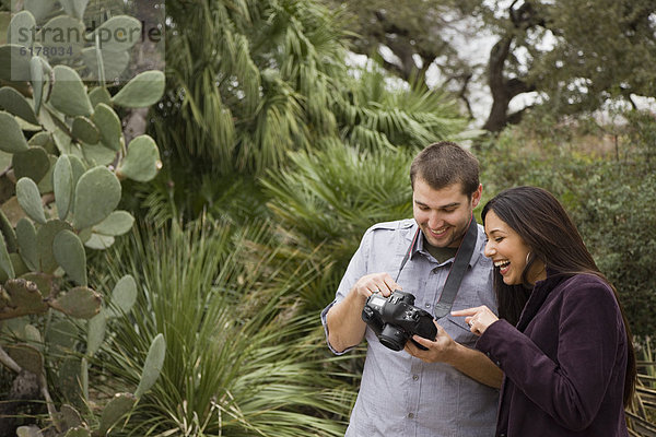 Couple looking at pictures on digital camera