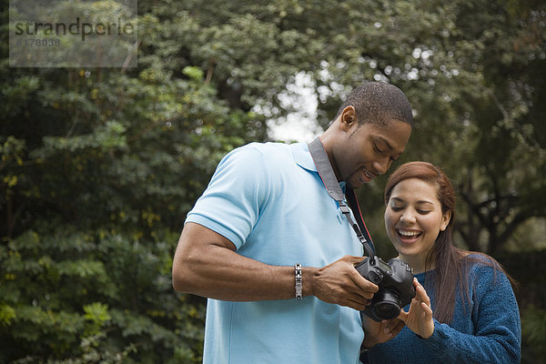 Couple looking at pictures on digital camera