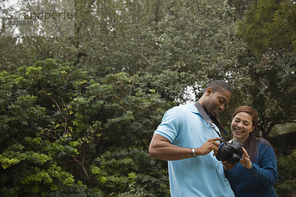 Couple looking at pictures on digital camera