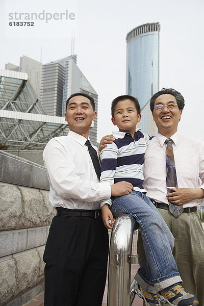 Chinese grandfather  father and son together outdoors