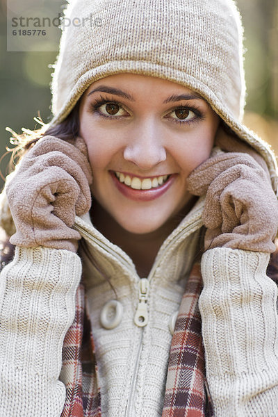 Mixed race woman in cap  scarf and gloves