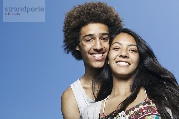 Smiling teenage couple outdoors