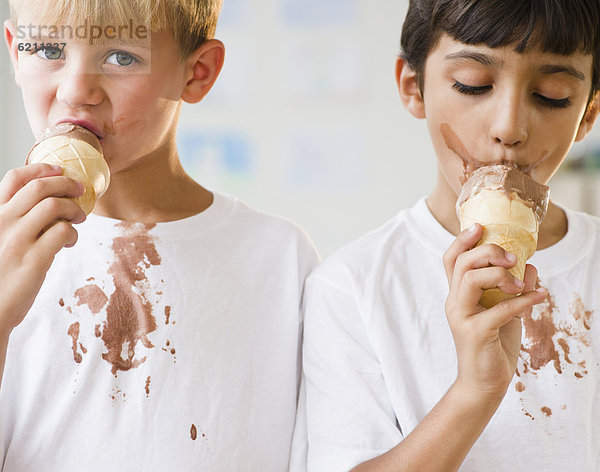 kegelförmig  Kegel  Junge - Person  heraustropfen  tropfen  undicht  Eis  essen  essend  isst  Sahne