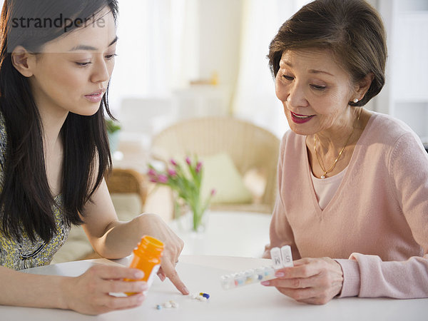 Japanese daughter explaining  medication to mother