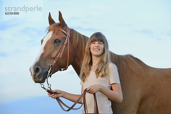Lächelnde Teenagerin mit Pferd