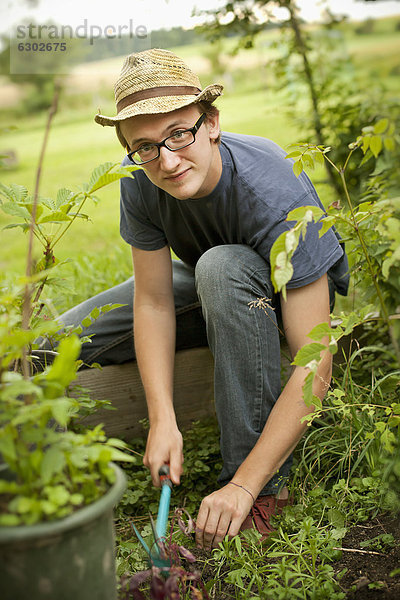 Junger Mann bei der Gartenarbeit