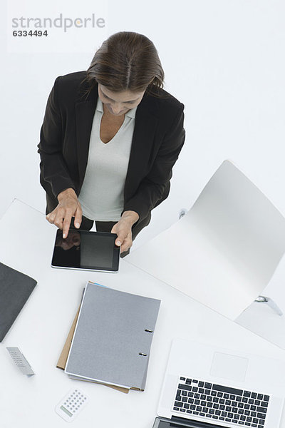 Geschäftsfrau am Schreibtisch mit digitalem Tablett