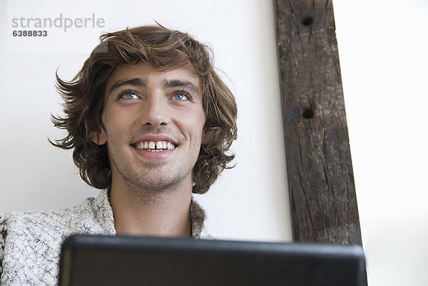 Teenager Junge mit Laptop im Haus