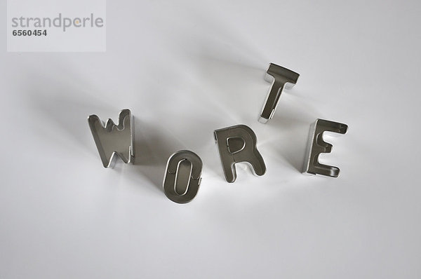 Metal letters on white background