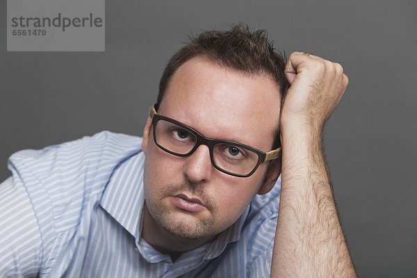 Businessman thinking against gray background