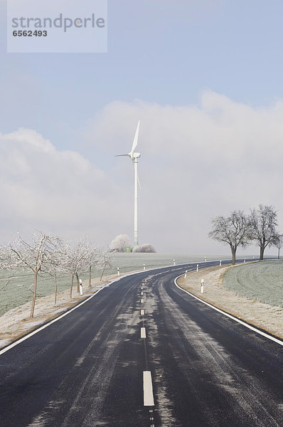Germany  Saxony  View of empty road with wind turbine