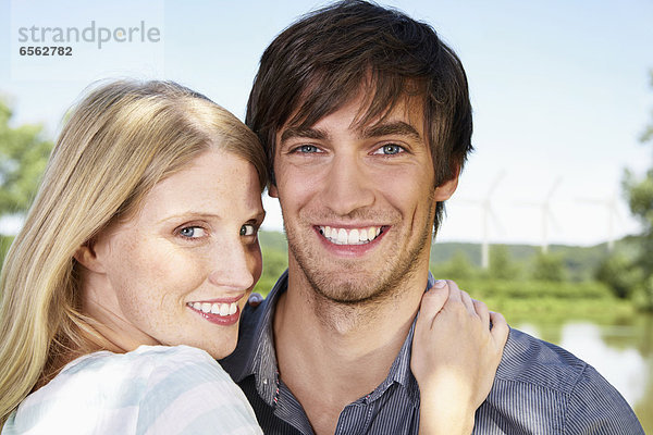 Germany  Cologne  Young couple embracing  smiling  portrait