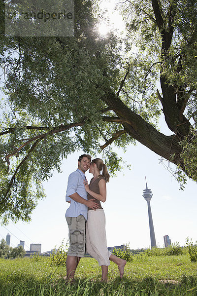 Germany  North Rhine Westphalia  Duesseldorf  Couple embracing  smiling