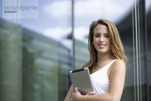 Europe  Germany  North Rhine Westphalia  Duesseldorf  Young student with digital tablet  smiling  portrait