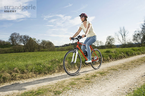 Mature woman riding electric bicycle