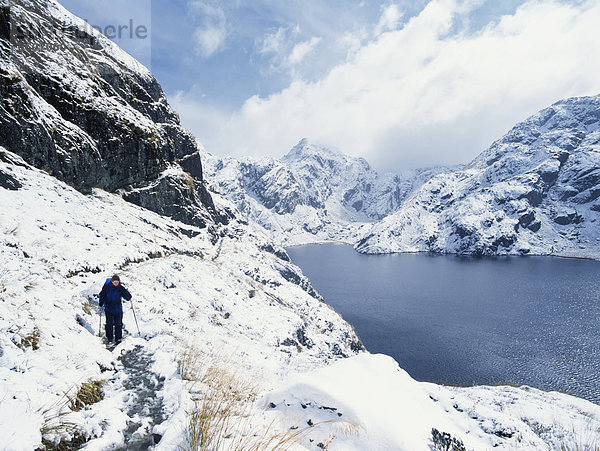 Woman Walking In A Snowy  Mountainous Landscape