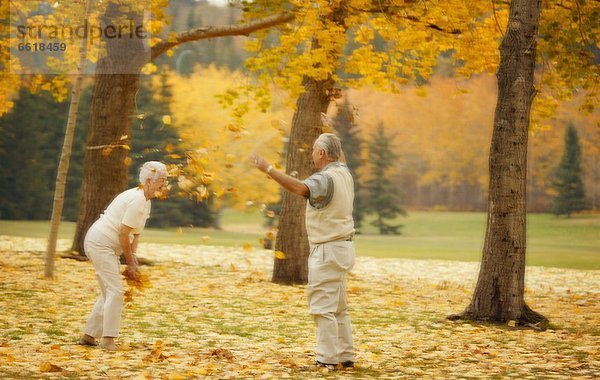 Couple Throw Leaves At Each Other