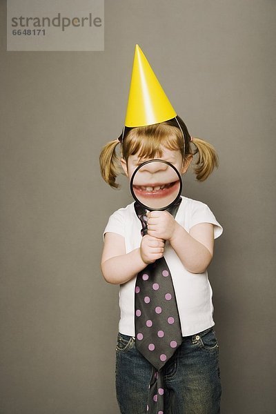 Littly Girl In Party Hat  Holding A Magnifying Glass