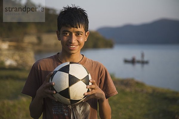 Junge - Person  halten  Fußball  Ball Spielzeug