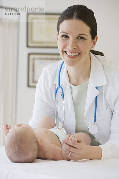 Frau Doktor examining baby