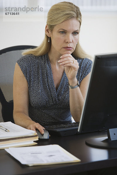 Businesswoman looking at computer