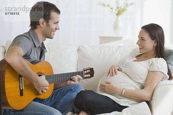 Mann Ehefrau Hispanier Schwangerschaft Gitarre spielen