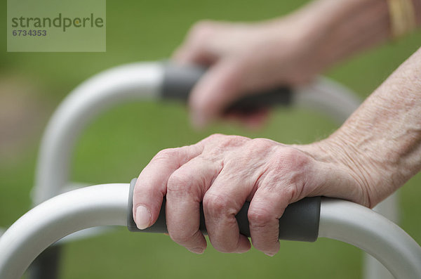 Senior walking with walker  close-up of hands