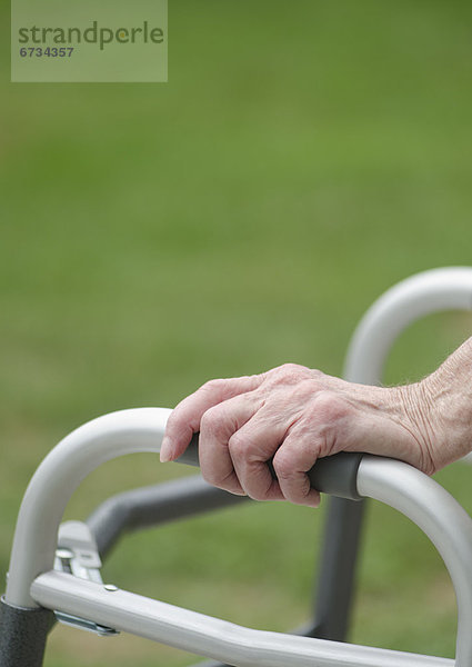 Senior walking with walker  close-up of hands