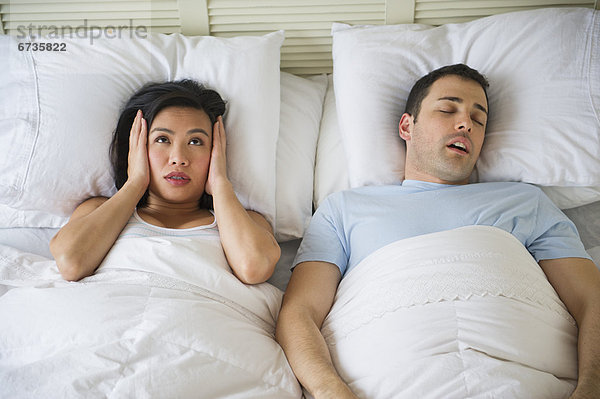 Couple in bed  man snoring