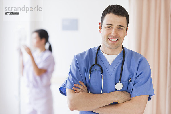 Portrait of doctor  nurse in background