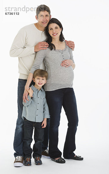 Studio portrait of father  pregnant mother and son (4-5)