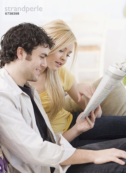 Couple reading newspaper