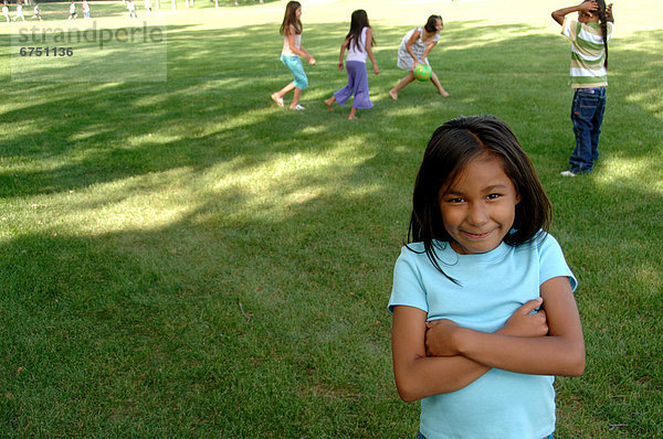 Young Girl in Park  Friends in Background