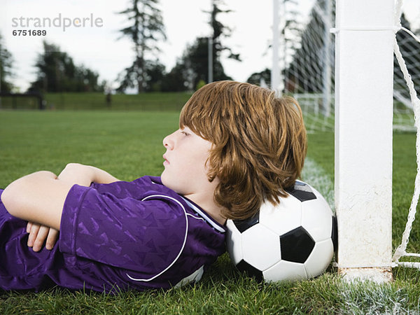 liegend  liegen  liegt  liegendes  liegender  liegende  daliegen  Junge - Person  Ziel  Fußball  Ball Spielzeug