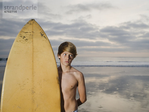 stehend  nebeneinander  neben  Seite an Seite  Junge - Person  Surfboard