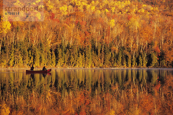 Canoeists at Sunrise  Lac Bouchard  La Mauricie National Park Quebec.
