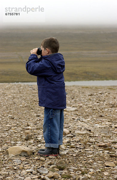 Boy Examining Horizon  Tundra near Cambridge Bay Nunavut