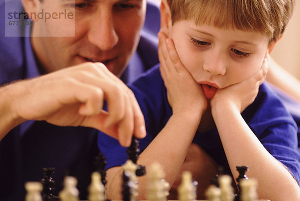 Menschlicher Vater Sohn Schach spielen