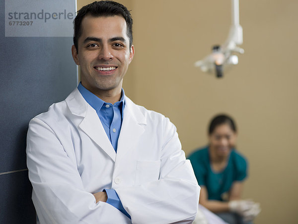 Portrait of dentist  dentist and patient in background