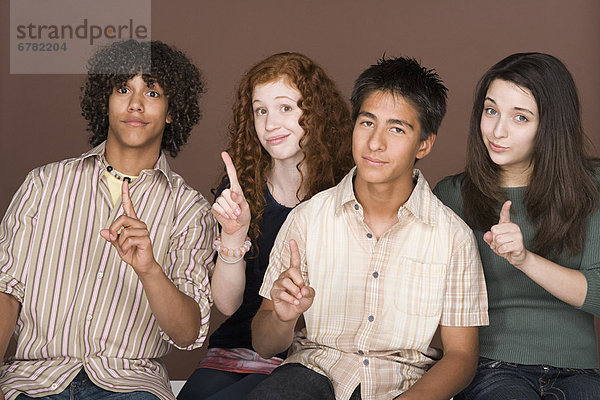 Portrait of teenagers (14-15 16-17) with fingers up