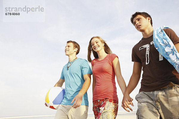 Friends walking on beach